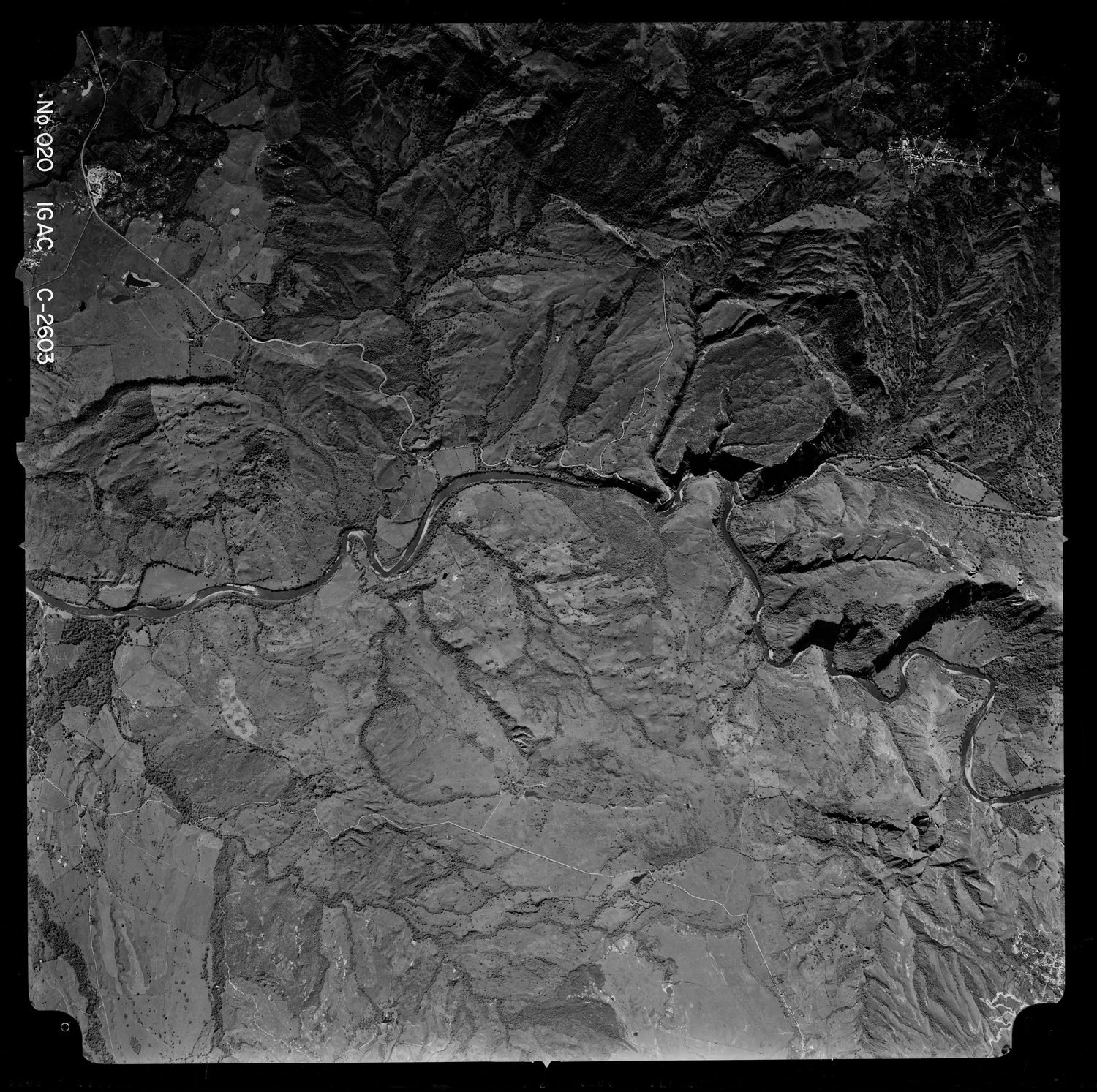 Fotograma aéreo vertical del IGAC mostrando un valle con drenajes, escarpes y geoformas de ladera